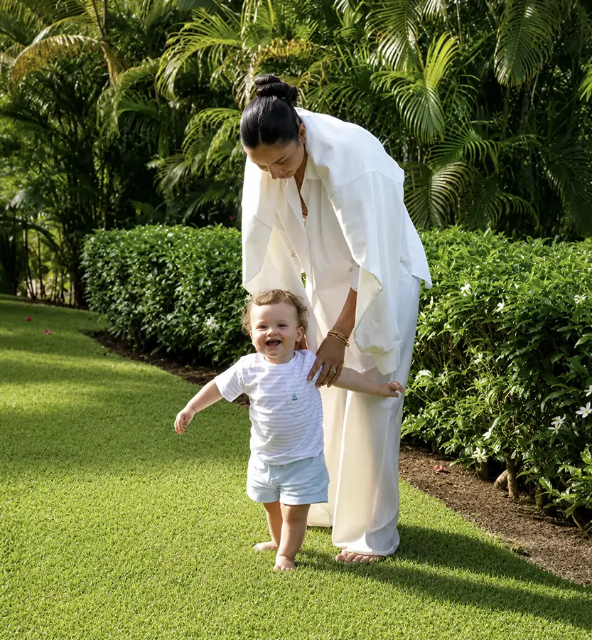Mother and child walking through Lucero's lush landscaped gardens