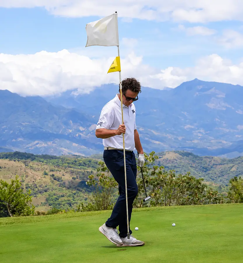 Golfer lining up a putt on the green at Lucero Golf and Country Club