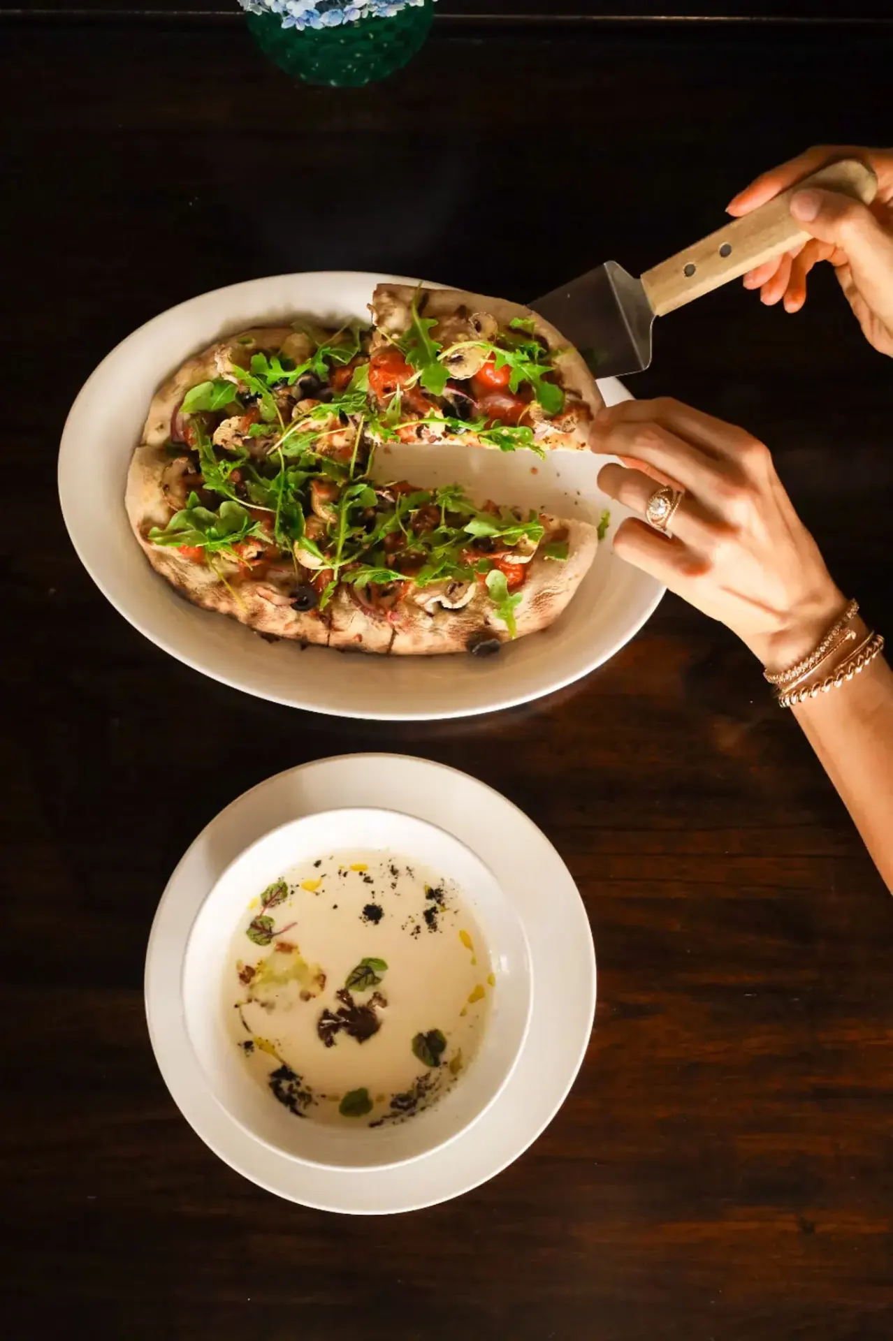 Wood-fired pizza with arugula and mushroom soup